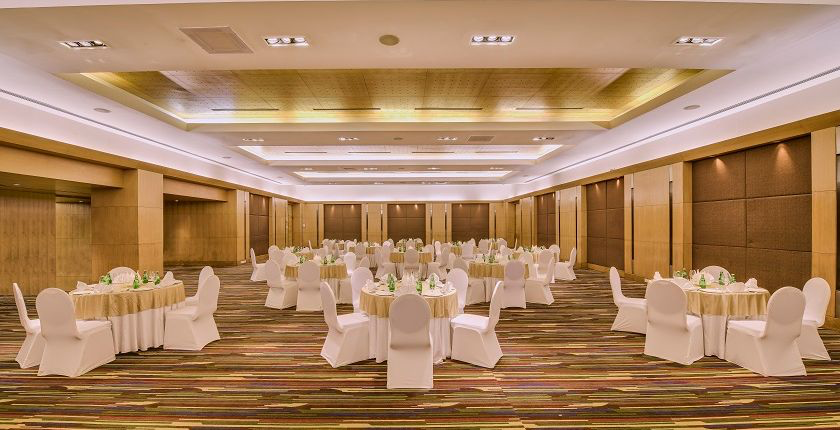 Banquet hall at The Lalit Ashok Bengaluru set with round tables